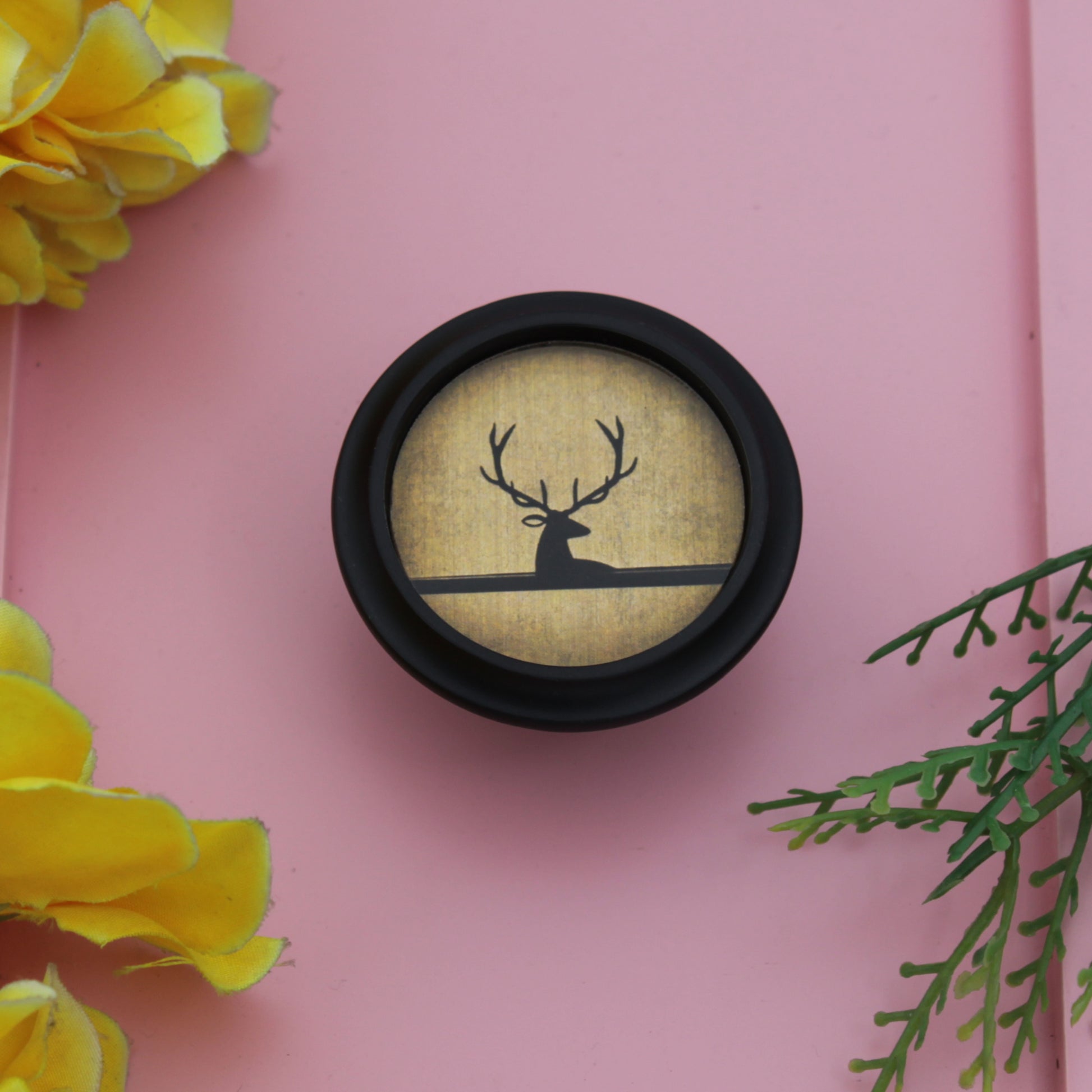 Decorative item with deer silhouette on a pink background 