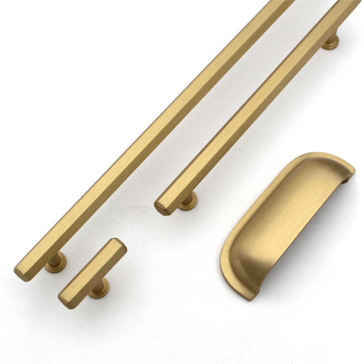 Set of gold cabinet handles on a white background
